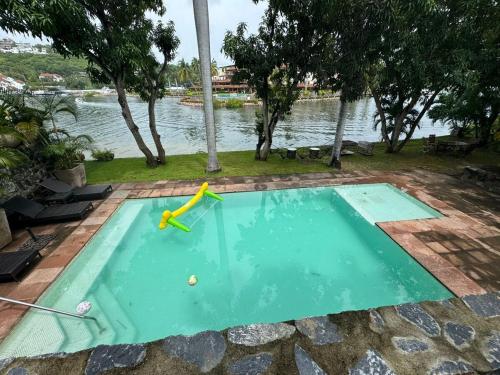 a small swimming pool with a toy in it at Exclusive Luxury Waterfront Villa in Marina Real in Zihuatanejo