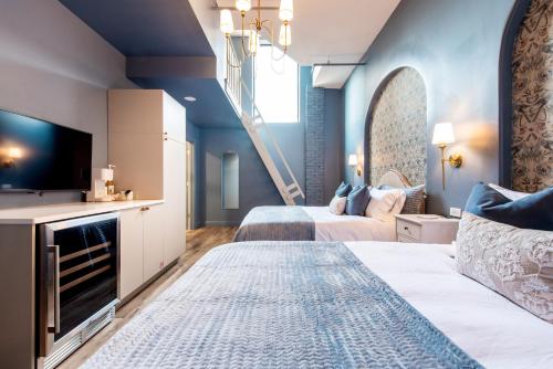 a hotel room with two beds and a staircase at Hollyhock Suite 506 in Louisville