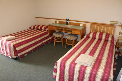Postel nebo postele na pokoji v ubytování Hermitage Motel