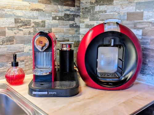 a red blender sitting on a counter next to a sink at Chalet Talisman auf der Riederalp in Riederalp