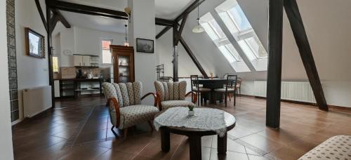 a room with chairs and a table and a dining room at Apartmán Coralina in Zvolen