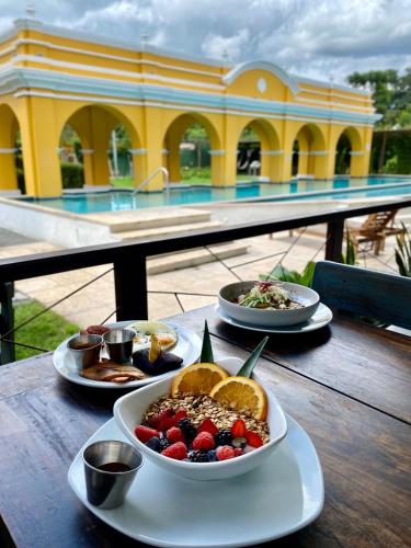a table with plates of food on top of a building at Elite Maya Hotel & Spa in Antigua Guatemala