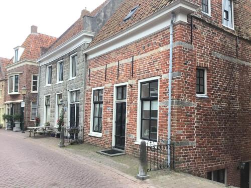 a brick building on the side of a street at Solwerderstraat 12 - Hangende Keuken in Appingedam