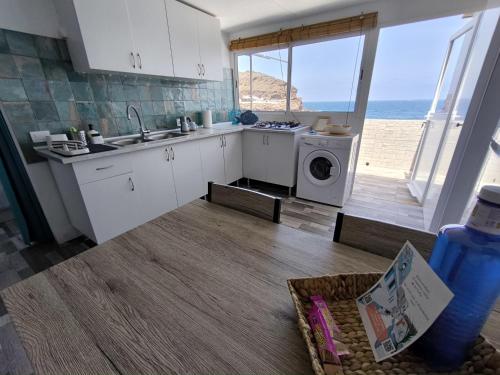 a kitchen with a sink and a washing machine at Ocean Attic Tufia in Telde