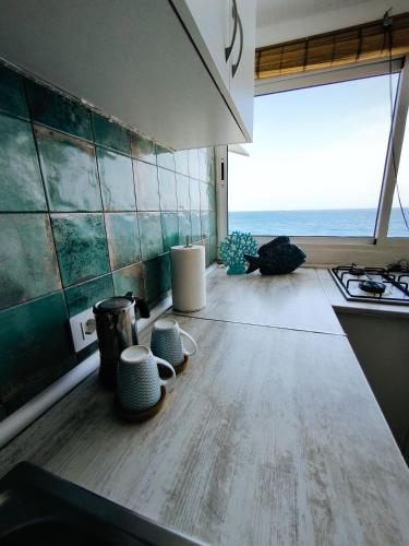 a kitchen with a counter and a stove and a window at Ocean Attic Tufia in Telde