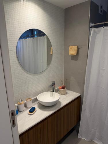a bathroom with a sink and a mirror at Segundo hogar in Luján