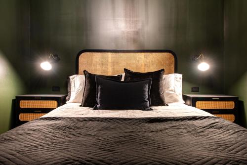 a bedroom with a large bed with two night stands at Hollyhock Suite 505 in Louisville
