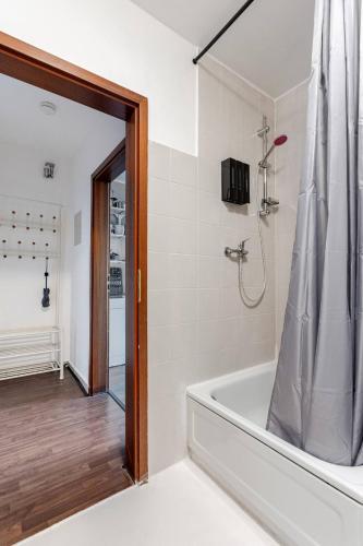 a white bathroom with a tub and a shower at Exklusiv Küche Office Streaming Minibar 6311 in Bonn
