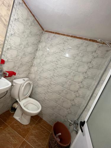 a bathroom with a toilet and a sink at Casa Inas in Chefchaouene