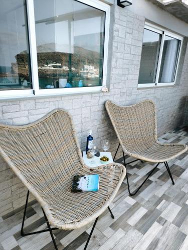 two chairs and a table on a patio at Ocean Attic Tufia in Telde
