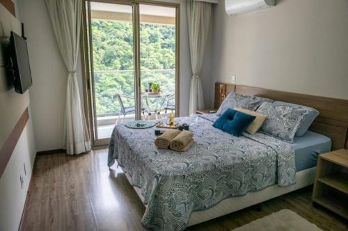 a bedroom with a bed with two towels on it at Rio Centro Stay in Rio de Janeiro