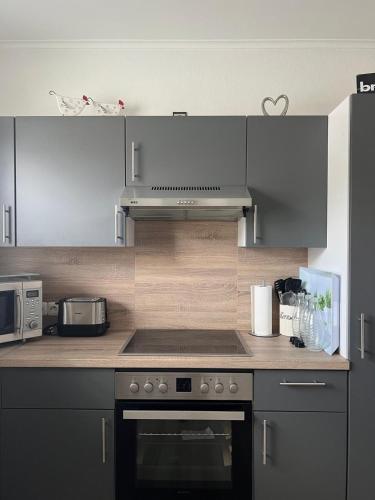 a kitchen with a stove top oven in a kitchen at Ferienwohnung Dammer in Niederkrüchten