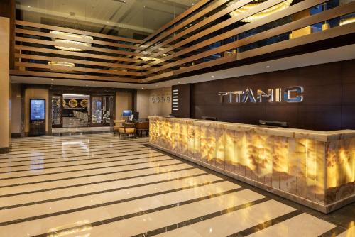 a lobby of a hotel with a waiting area at Titanic City Taksim in Istanbul