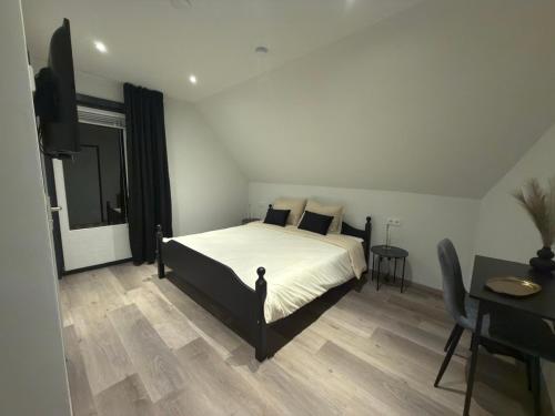 a bedroom with a bed and a flat screen tv at Landhaus Pension Jagdschlösschen in Willingen