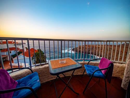 a balcony with a table and chairs and the ocean at Apartamento Monis Natura in Icod de los Vinos