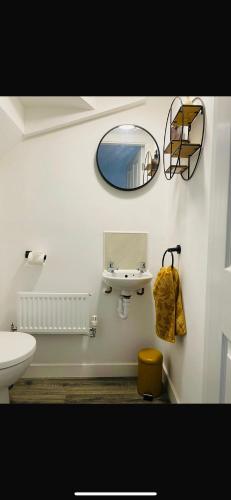 a bathroom with a sink and a mirror on the wall at Lancaster Retreat in Lancaster