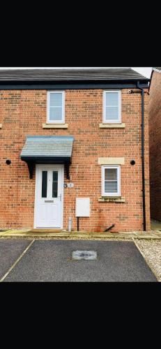 a brick house with a white door and windows at Lancaster Retreat in Lancaster