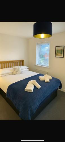 a bedroom with a large bed with towels on it at Lancaster Retreat in Lancaster