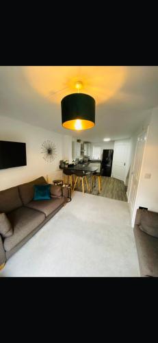 a living room with a couch and a table at Lancaster Retreat in Lancaster
