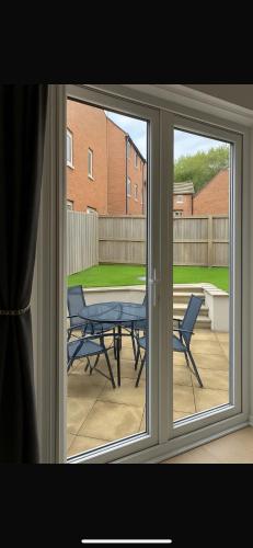 a view of a patio with a table and chairs through a window at Lancaster Retreat in Lancaster