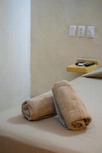 a towel sitting on top of a bed at Hotel Real Monrey in Zihuatanejo
