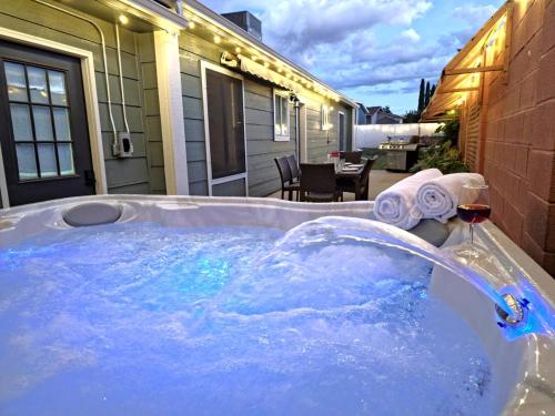 a jacuzzi tub with a glass of wine at Hot Tub, Game Room, Kayaks, Boat Parking, Backyard, King, Fire Pit, Pets, WD in Page