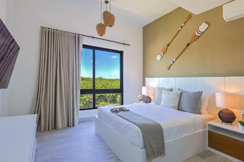a bedroom with a large bed and a large window at Elegant 3BR Condo Near Airport in Punta Cana