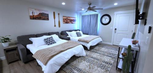 a living room with two beds and a couch at Hot Tub, Kayaks, Game Room, Boat Parking, Fire Pit, King, WD in Page