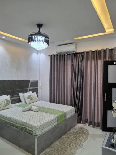 a bedroom with a bed and a large window at Seckebe Immo SUITE 1 in Dakar