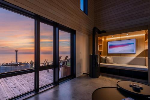 a room with a tub and a large window with a view at Birch - Luxury 2 bdrm Cottage in Chimney Corner