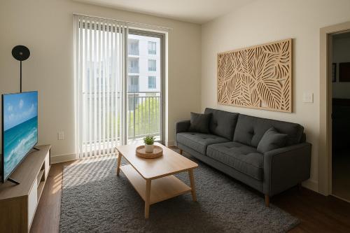 a living room with a couch and a tv at Central Birmingham Stylish Midrise Unit in Birmingham