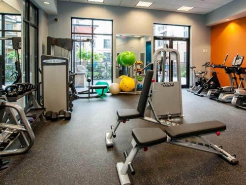 a gym with several treadmills and machines at Central Birmingham Stylish Midrise Unit in Birmingham