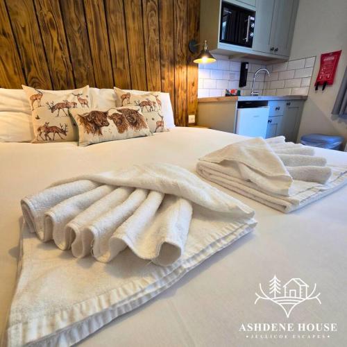 two towels sitting on top of a bed at The Woodland Hare - Room 5 - New Forest in Dibden