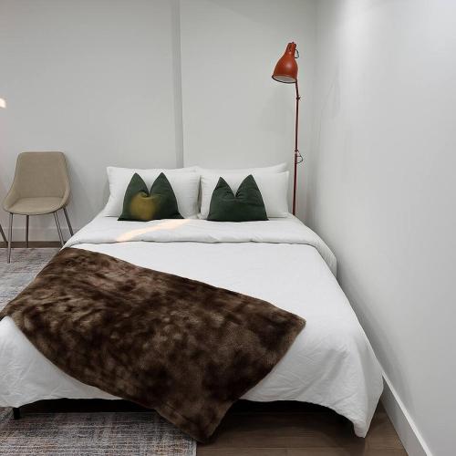 a bedroom with a bed with a fur blanket on it at Lux Basement Apartment Getaway in Brampton