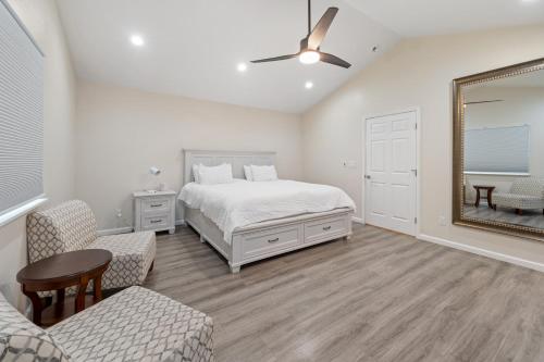 a bedroom with a bed and a mirror at The Modern Re-Joyce Retreat in Hamilton Acres