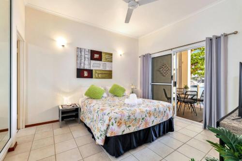 a bedroom with a bed and a balcony at Cullen Bay Perfection in Larrakeyah