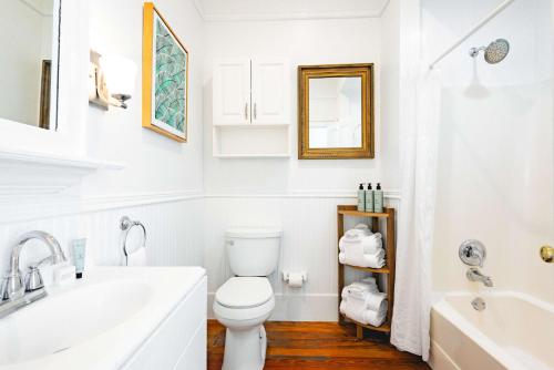 une salle de bain blanche avec un lavabo et des toilettes dans l'établissement Key Lime Cottage, à Key West