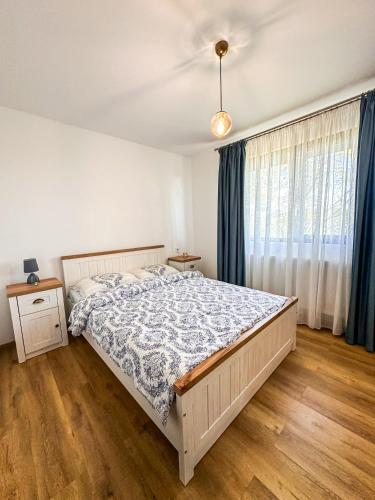 a bedroom with a bed and a window at Cabana Vatra Sloveanu 