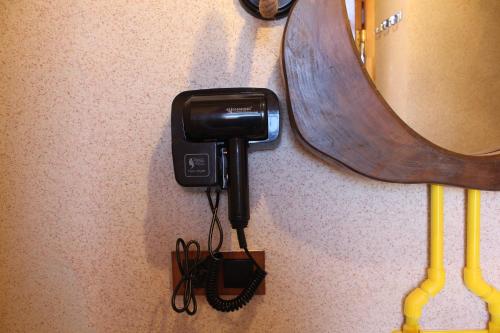 a phone hanging on a wall next to a skateboard at Tun Arevin in Vaykʼ