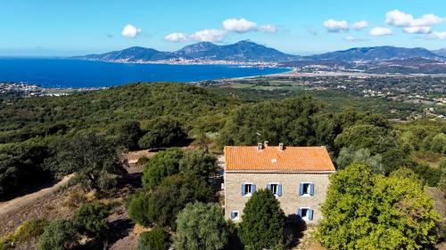 an aerial view of a house with an orange roof at Maison de maître en pierre de 1831 avec vue sur la mer à Porticcio in Porticcio