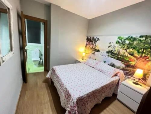 a bedroom with a bed and a painting on the wall at Mar y Sol Almuñécar Apartment in Almuñécar