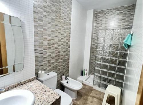 a bathroom with a toilet and a sink and a shower at Mar y Sol Almuñécar Apartment in Almuñécar