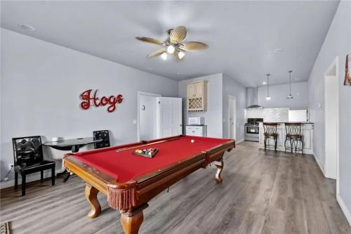 a living room with a pool table and a kitchen at Lakeside Retreat - Large Deck & Game Room with Views in Bland