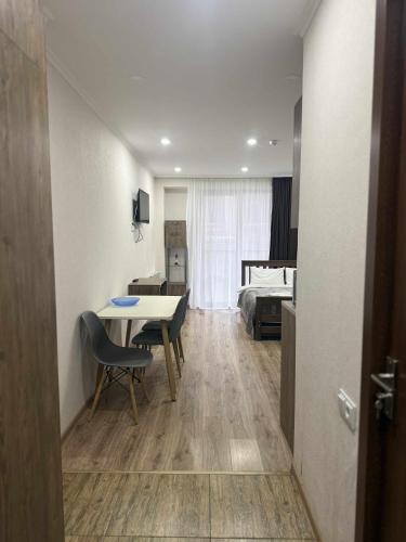 a room with a table and a bedroom with a bed at Apartment N111 Loft 2 in Gudauri