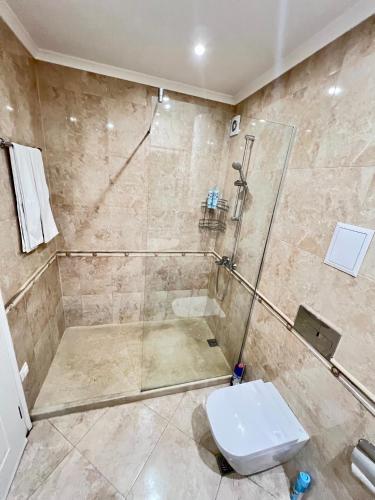 a bathroom with a shower and a toilet at Central Home with Underground Parking in Varna City