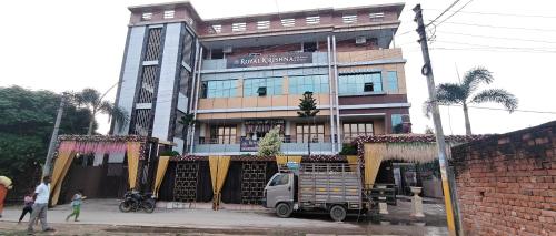 a building with a truck parked in front of it at Hotel Royal Krishna in Gorakhpur