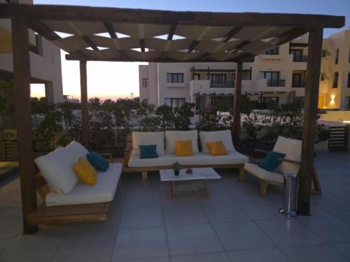 a group of couches sitting on a patio at ElGouna, Elegant 1Bedroom, private patio in Fanadir Marina in Hurghada
