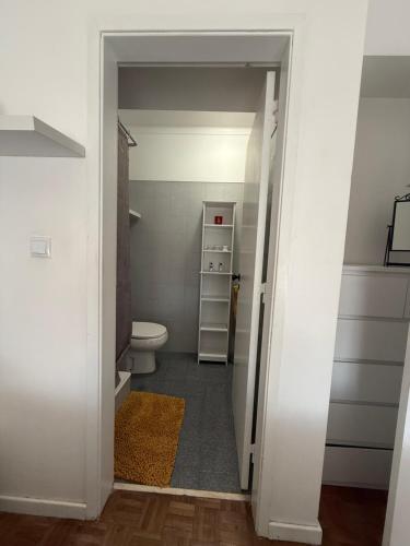 baño con aseo y puerta a un armario en Apart Lisbon Airport, en Lisboa