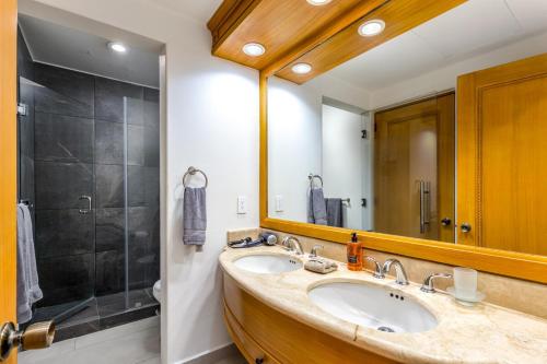 a bathroom with a sink and a shower at Beachfront luxury Condo w Pool in Cabo San Lucas