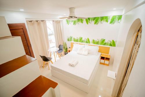 a small bedroom with a white bed and a window at Hayya Hayya Villas in Ocoy
